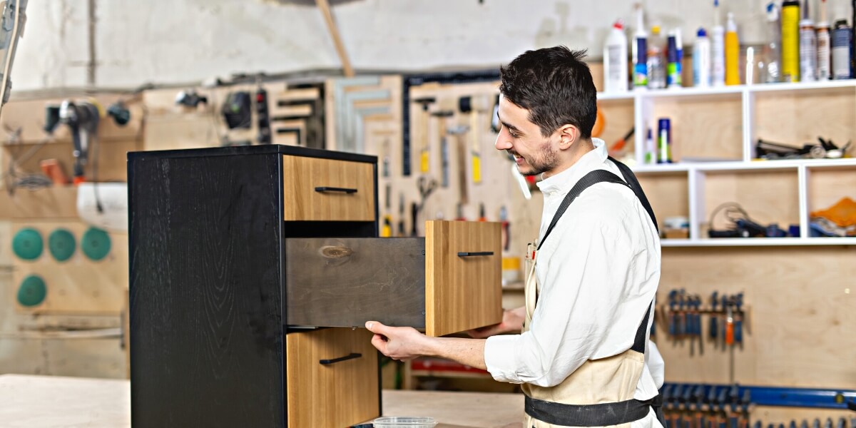 Cabinet maker creating a custom set of drawers in a workshop