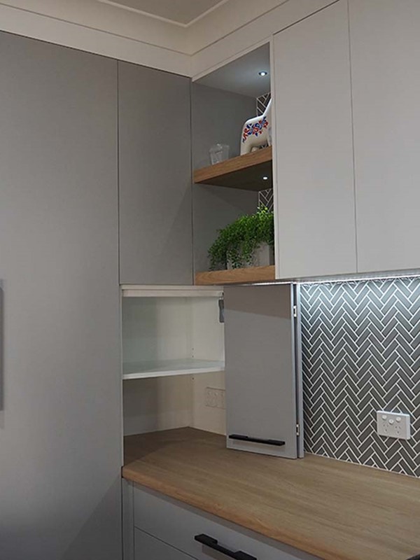 Kitchen cabinetry showing hidden bench-top