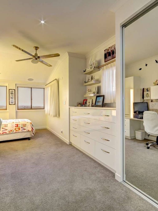 Bedroom with built-in desk and cupboards