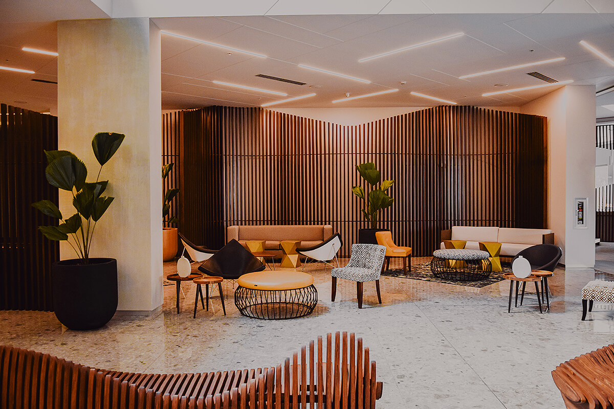 Warm tones with vertical timber slats make unique furniture and matching fitout in office waiting area