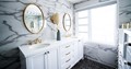 White bathroom with classic fixtures and white and black marble look tile walls