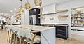 Kitchen designed with custom cabinetry in white, black and gold