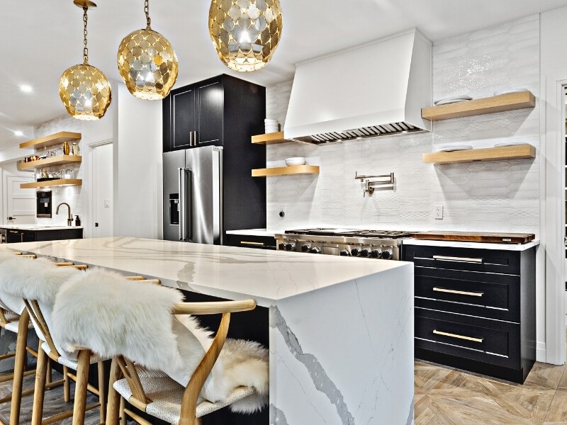 Kitchen designed with custom cabinetry in white, black and gold