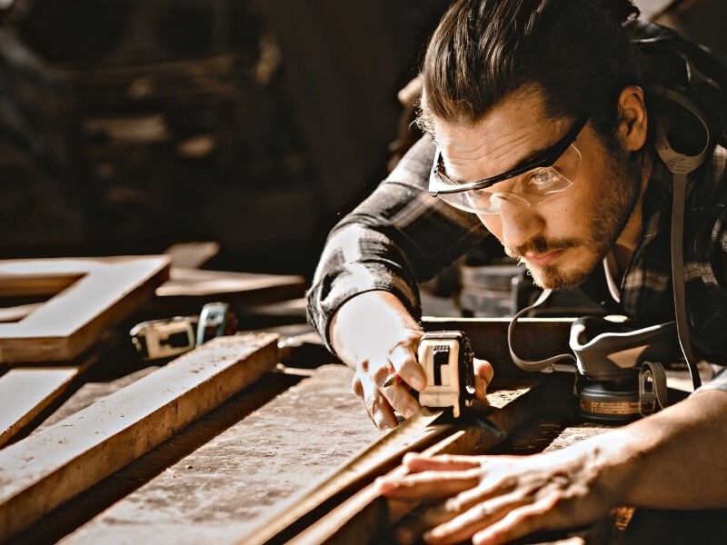 Carpenter measuring wood