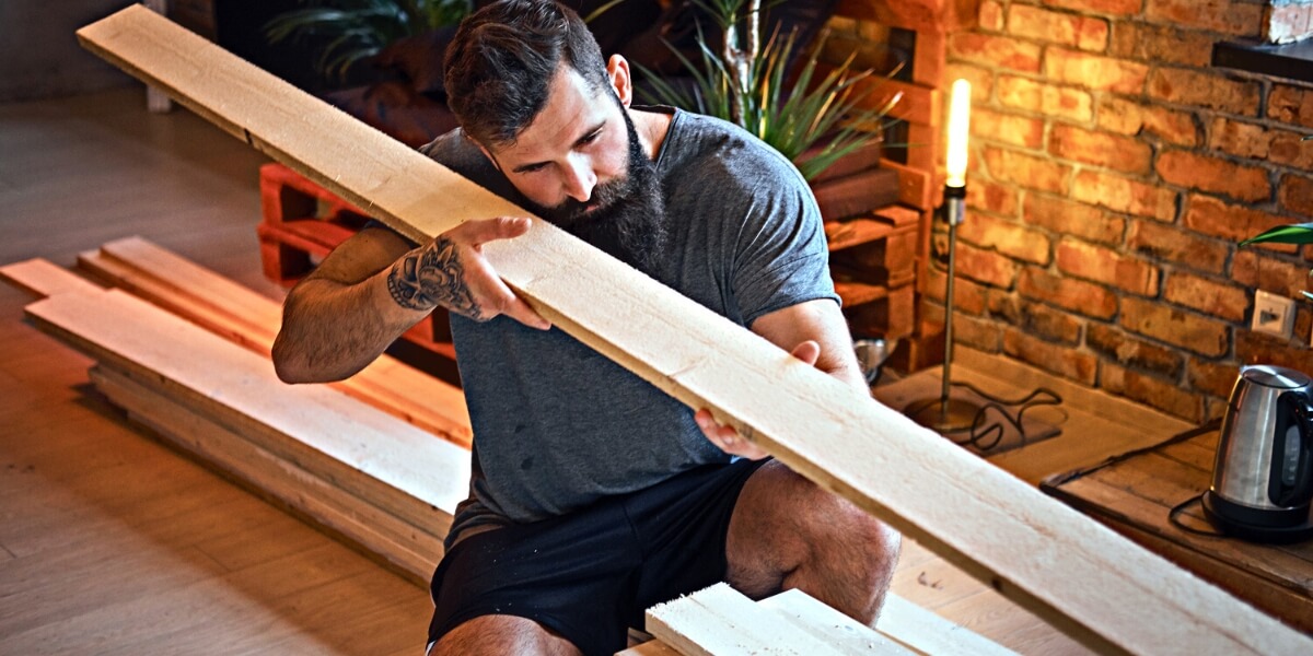 Carpenter checking out a piece of wood during an interior design project