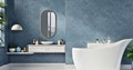 Customer bathroom renovation with blue walls and bathtub