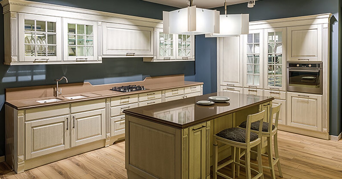 Custom kitchen cupboards in white and wood with blue background