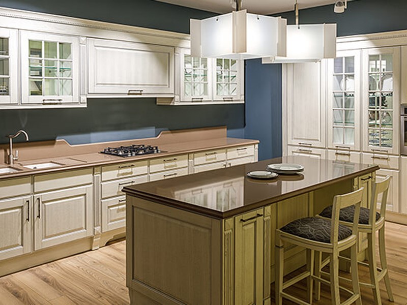 Custom kitchen cupboards in white and wood with blue background