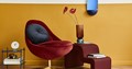 Unique living room with burgundy chair and yellow walls