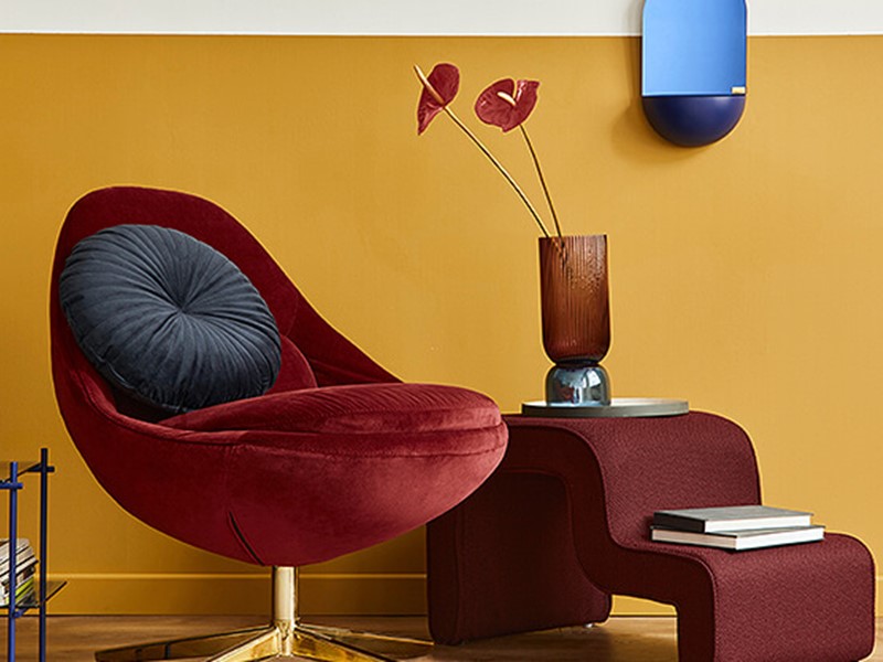 Unique living room with burgundy chair and yellow walls