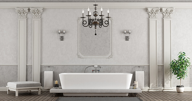 Chandelier over bathtub in white bathroom
