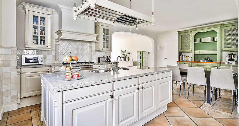 Custom kitchen with green cupboard