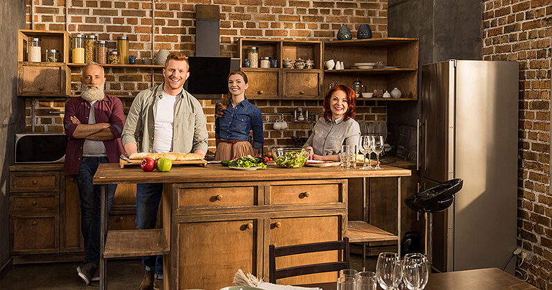 Farmhouse kitchen with family standing in it