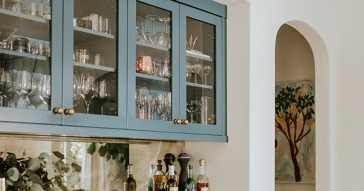 Two tone glass and blue cabinets