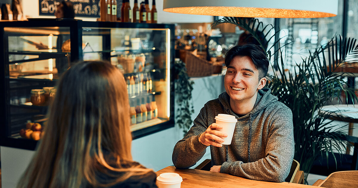 Couple sitting at a cozy cafe drinking coffee