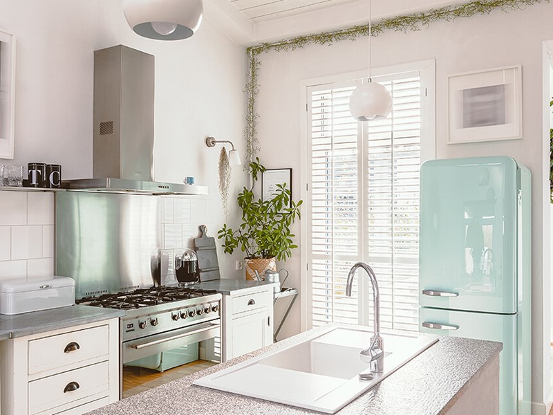 Coastal kitchen with blue fridge