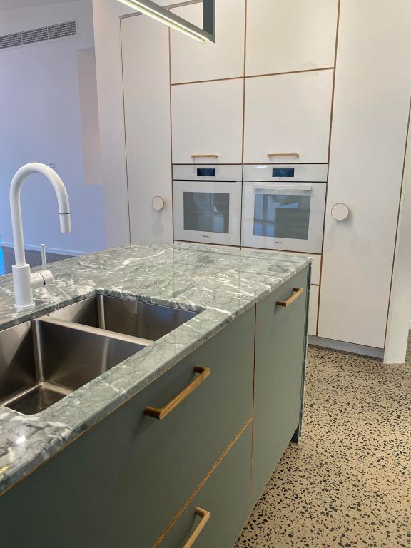 Kitchen sink with green drawers